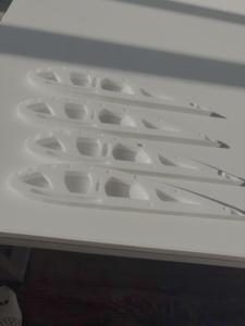 Four 3D-printed rib sections laid out before assembly